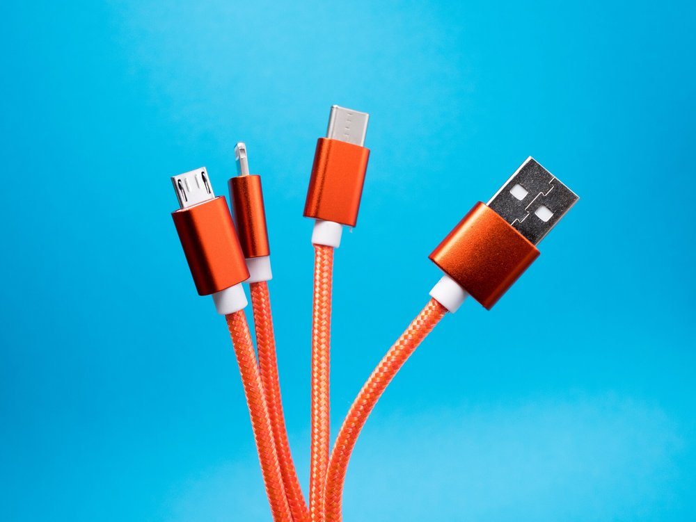 Orange USB cables on a blue background